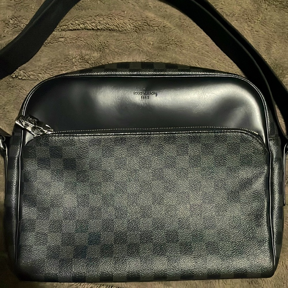 This Bag Can fit a Mac Book as well and is in immaculate condition .